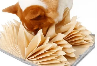 Close-up of a dog nose working through the felt pages of a snuffle mat