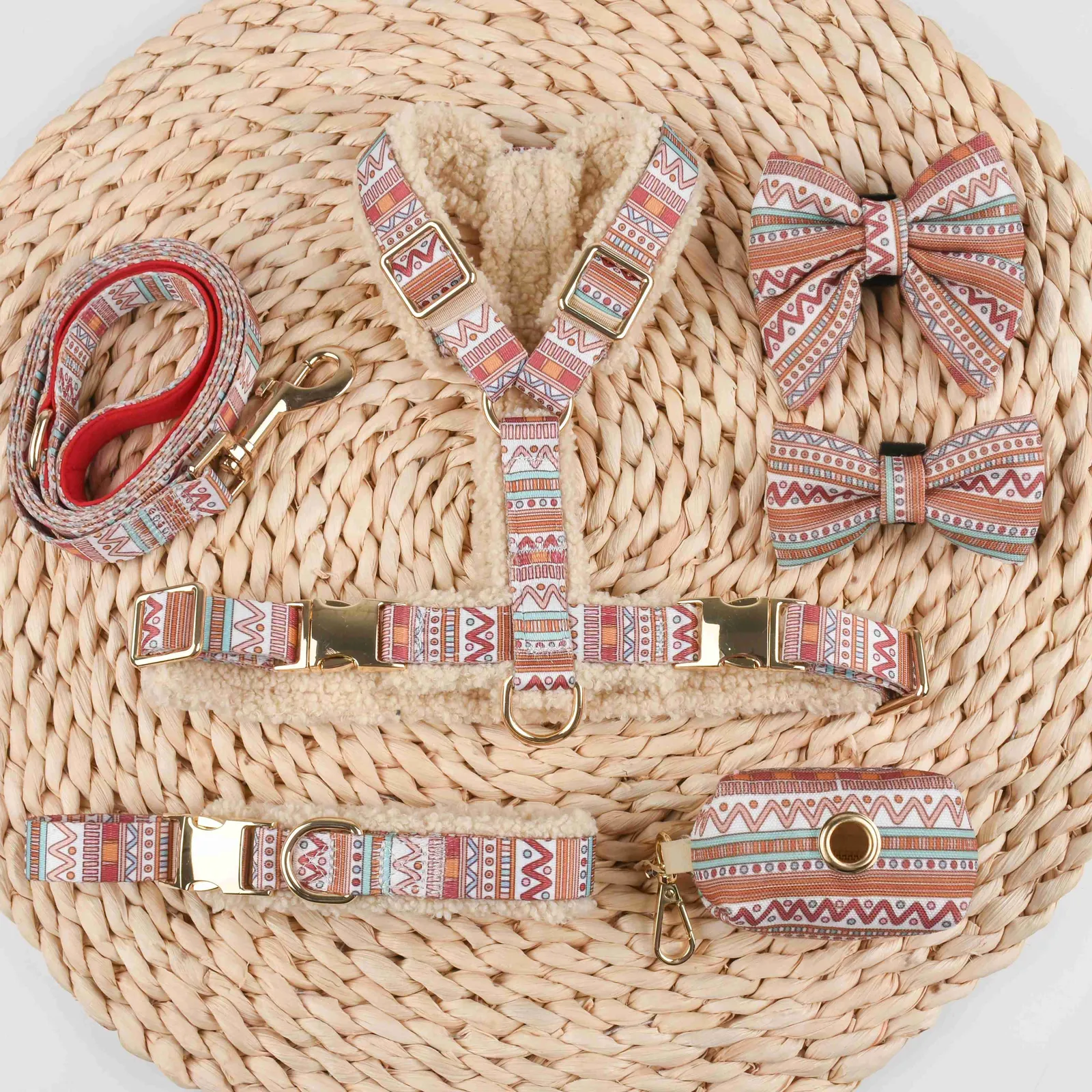 Cream teddy fleece dog harness and patterned leash on a woven mat, with two matching patterned bow ties